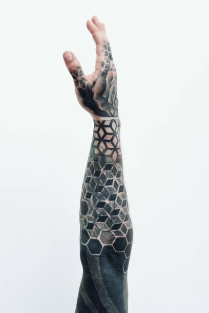 Creative arm sleeve tattoo Creative arm sleeve tattoo. Conceptual shot of tattooed male arm reaching up against white background tattoo arm stock pictures, royalty-free photos & images