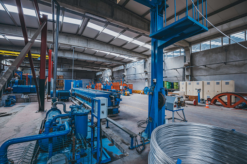 Heavy Machinery and steel cable processing equipments at the empty manufacturing plant in the factory warehouse
