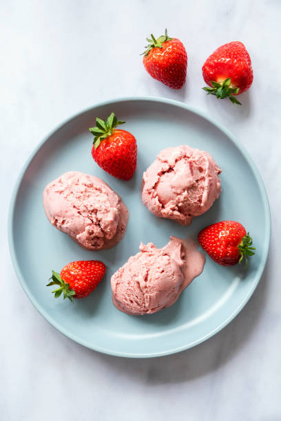 istock Blue ceramic plate with three scoops of strawberry ice cream 1272776186