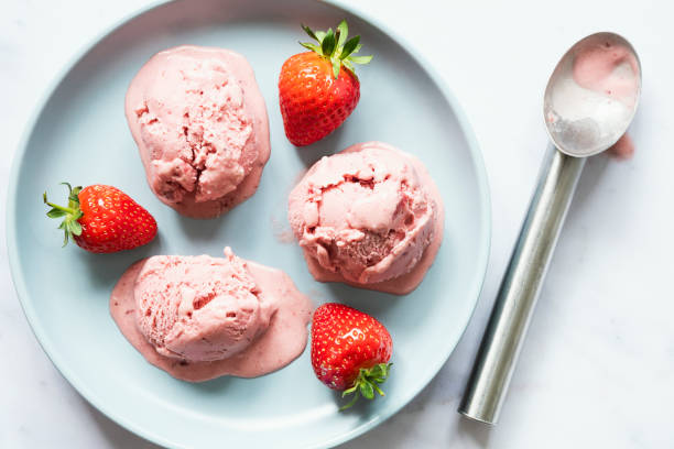 Blue ceramic plate with three scoops of strawberry ice cream