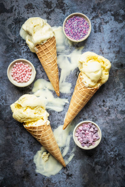 istock Vanilla ice cream cornets with bowls of sprinkles 1272776770