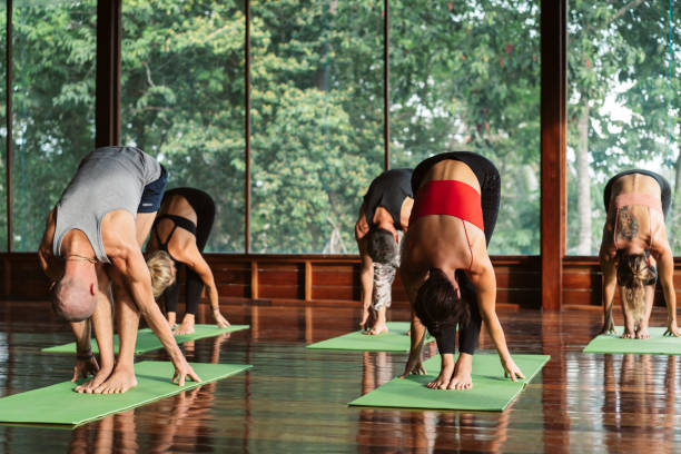 istock People practicing yoga at morning. 1272777750