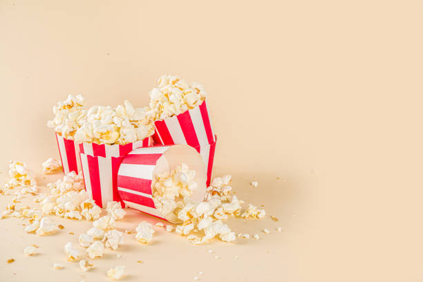 istock Tasty pop corn in small paper glasses 1272778301