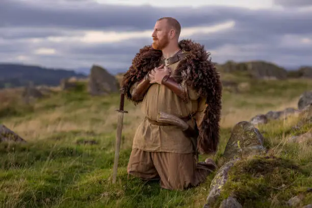 An individual viking warrior man resting on the highland moors