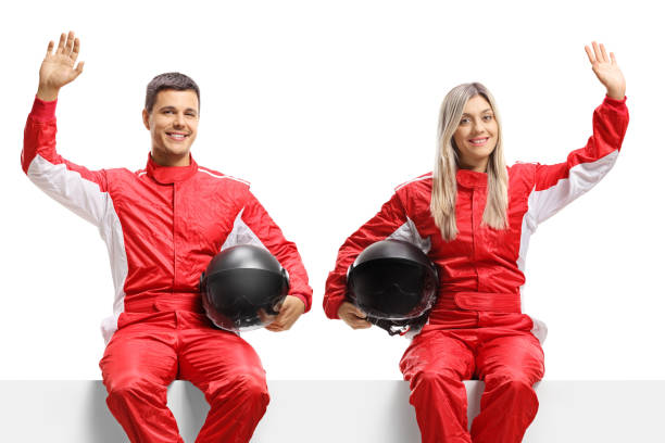 istock Car racers sitting on panel and waving 1272781643