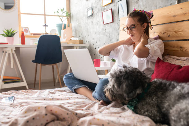 istock Woman having a neckache while working at home 1272783051