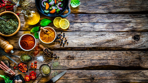istock Cooking background: multi colored spices, herbs and vegetables on rustic wooden table. Copy space 1272783663