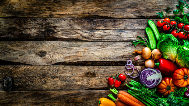 istock Healthy vegetables background: multi colored vegetables shot from above on rustic wooden table. Copy space 1272783664