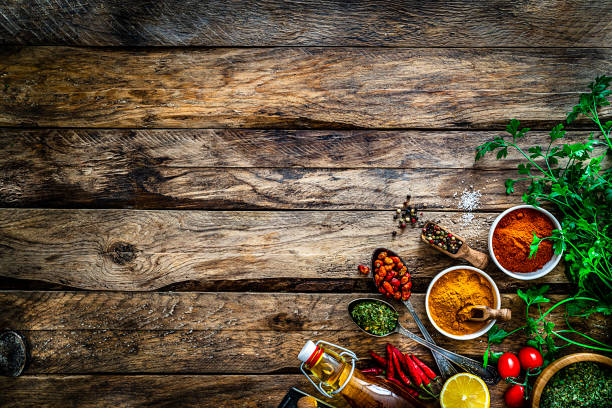 istock Cooking background: multi colored spices, herbs and vegetables on rustic wooden table. Copy space 1272783688