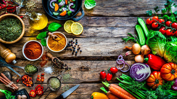 istock Cooking background: multi colored vegetables, spices and on rustic wooden table. Copy space 1272783710