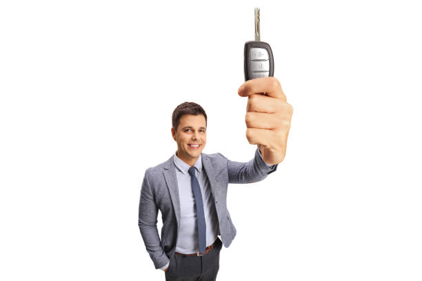 istock Professional young man showing a car key in front of the camera 1272784342