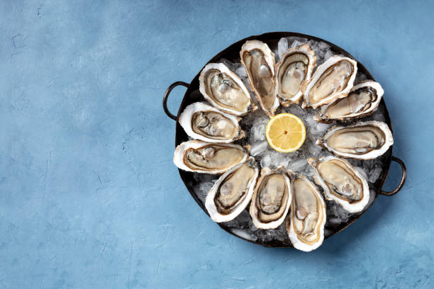 istock A dozen of oysters on ice, with a lemon, shot from above 1272784659