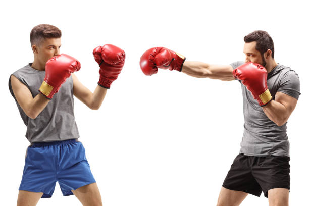 istock Young men fighting with boxing gloves 1272784766