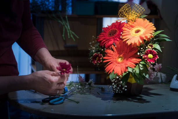 istock Hands of forist making flower bouquet 1272785089