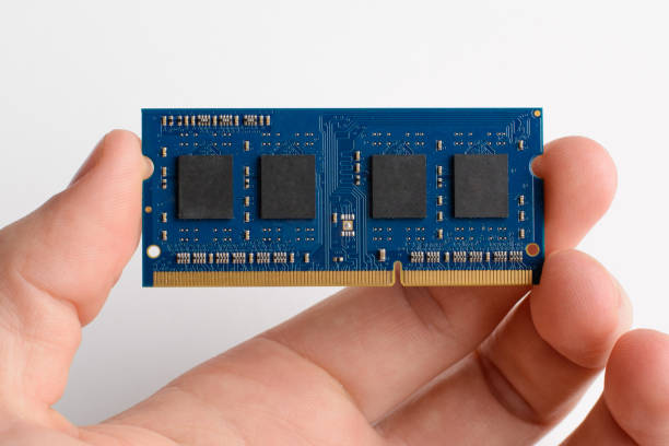 Upgrading laptop by adding module of RAM memory DDR memory card in man`s hand against white background installing laptop ram stock pictures, royalty-free photos & images