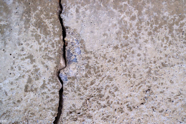 istock a crack in a concrete wall is vertical 1272789490