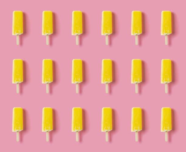 istock seamless yellow popsicle on a pink background 1272790151