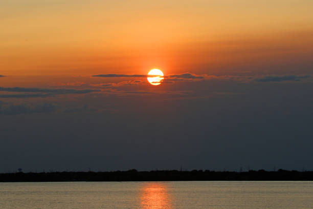 istock Vibrant sunset over a lake with deep rich tones 1272793154