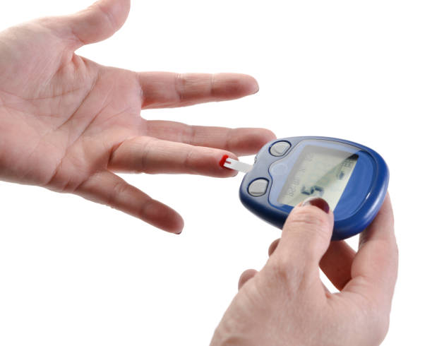 istock Measurnig blood sugar level isolated on white background 1272795703