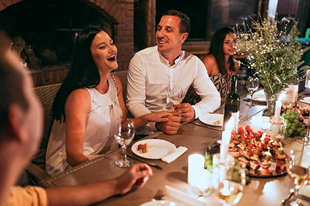 istock Happy young couple at dinner party 1272797294