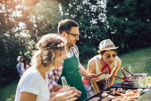 istock Friends having a barbecue party in nature 1272797339