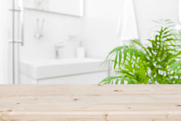 istock Blurred bathroom interior as background for product display on wood 1272798233