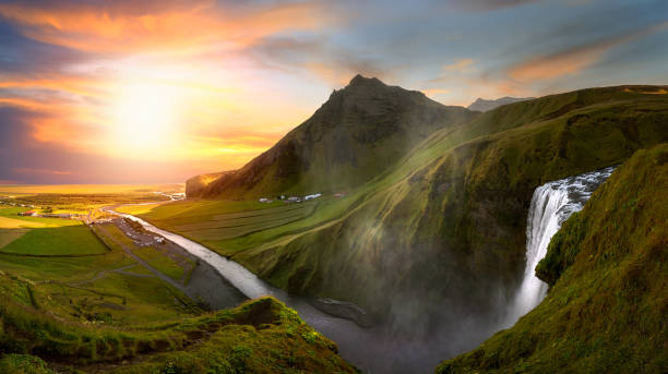 istock River flowing down from a waterfall in Iceland surrounded by mountains at sunset 1272798677