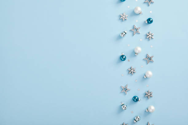 istock White and blue bauble, silver snowflake over blue background 1272800979