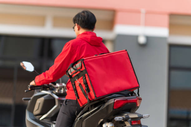 istock delivery man Prepare to deliver parcels to customers by motorbikes 1272802018