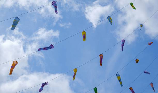istock colorful flags against blue sky with few clouds 1272802327