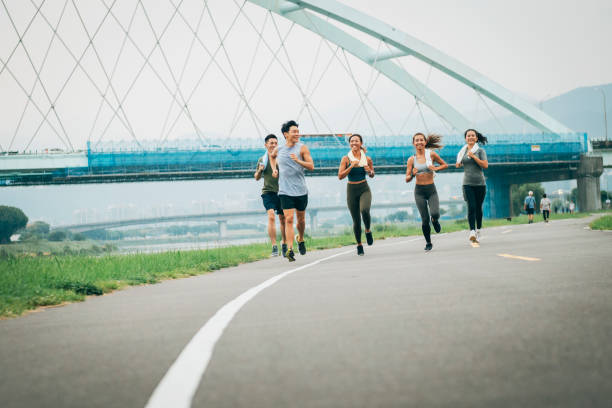 istock Friends jogging in the park together 1272802609