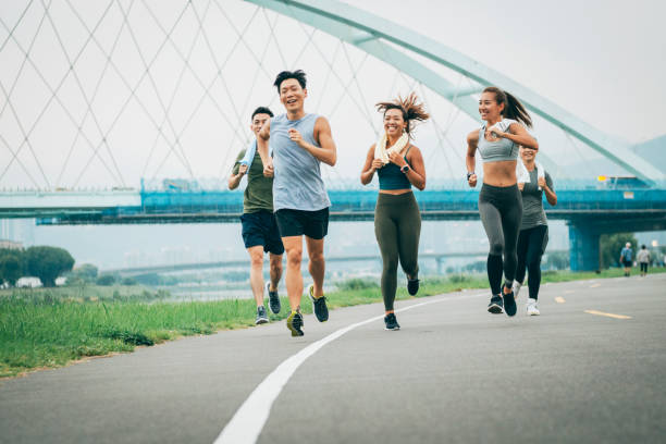 istock Friends jogging in the park together 1272802613