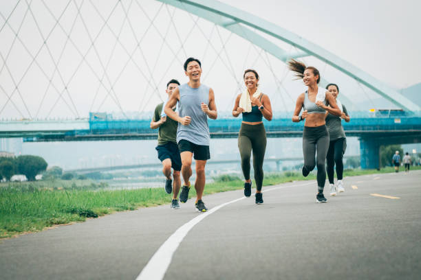 istock Friends jogging in the park together 1272802633