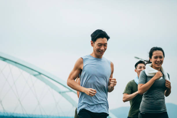 istock Friends jogging in the park together 1272802650