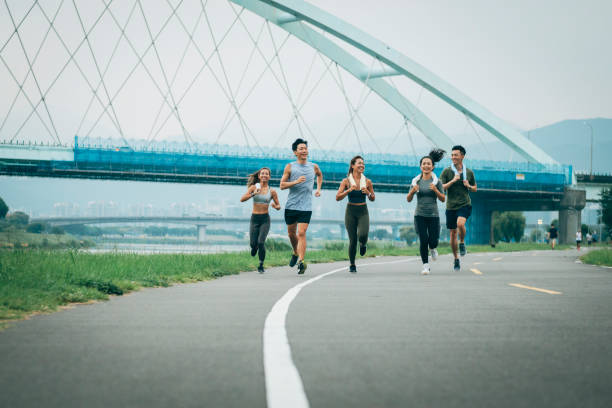 istock Friends jogging in the park together 1272802929