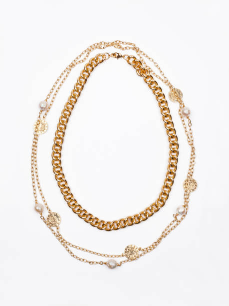 Two women`s gold necklaces on white background