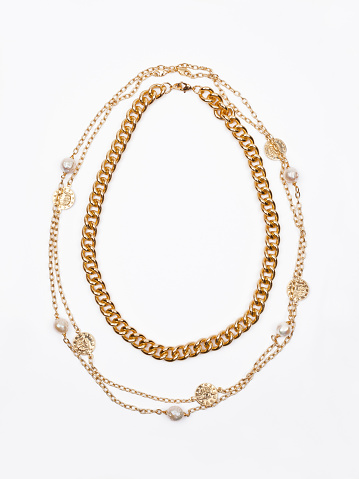 Golden necklace with Aquamarine gemstone isolated on white.