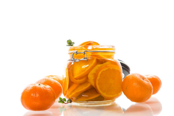istock tangerine jam in a glass jar isolated on white background 1272804127