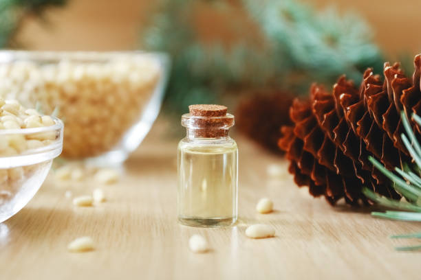 istock Pine nuts and bottles of essential oil. 1272805456