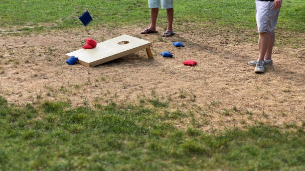 istock people playing the corn hole game with red and blue throwing corn filled bags recreational team sport 1272806343