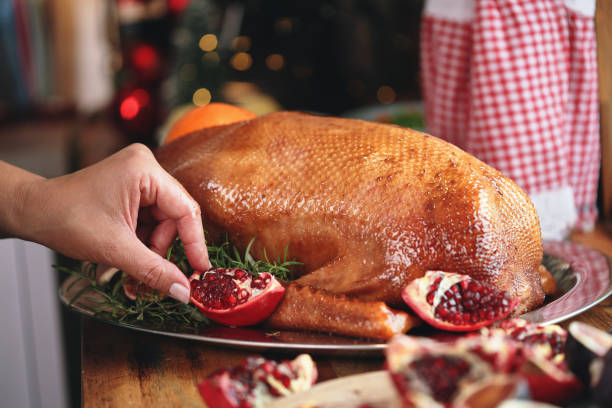 istock Preparing Stuffed Goose with Vegetables for Christmas Holidays 1272807139