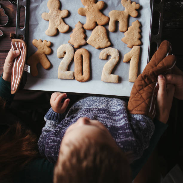 Little boy and parents with gingerbread cookies