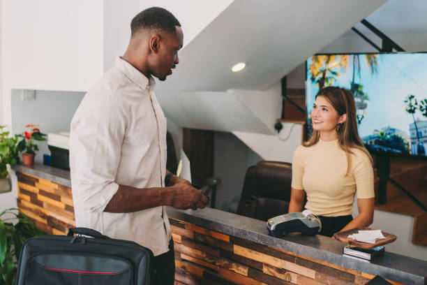 istock Businessman paying his stay in hotel 1272809407