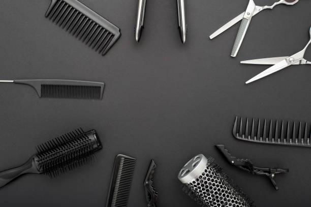 istock Flat lay composition with Hairdresser tools: scissors, combs, hair iron on black background with copy space for text in center. Frame. Hairdresser service. Beauty salon service. Hairdresser Set. 1272809542