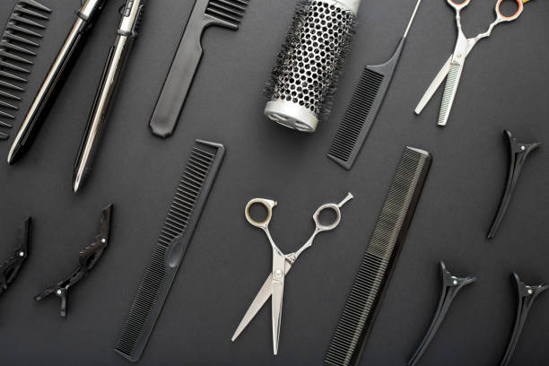 istock Flat lay composition with Hairdresser tools: scissors, combs, hair iron on black background. Frame. Hairdresser service. Beauty salon service. Hairdresser Set. 1272809550
