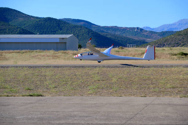 istock glider plane landing on the airfield 1272810490