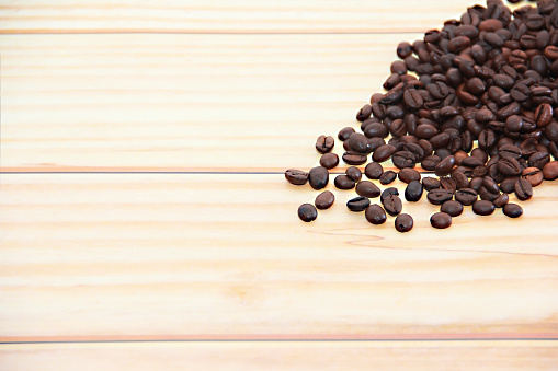 natural black coffee beans on wooden background