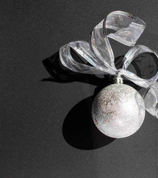 silver christmas ball on black background