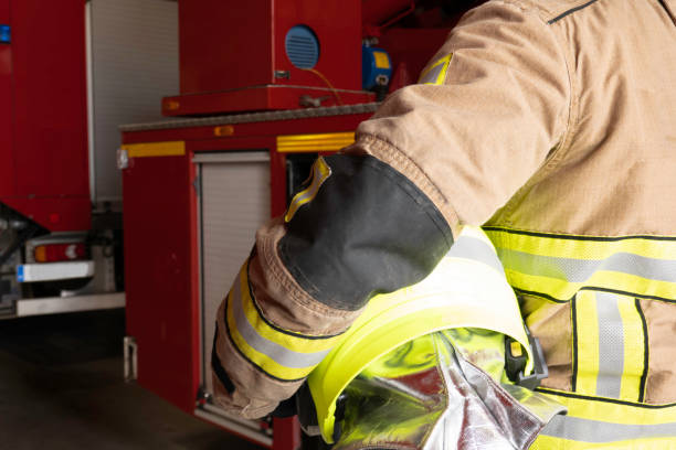 istock Firefighter wears helmet under arm 1272816889