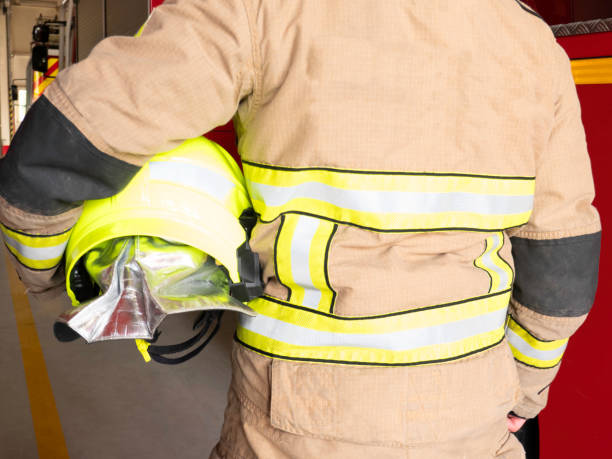istock Firefighter wears helmet under arm 1272817069